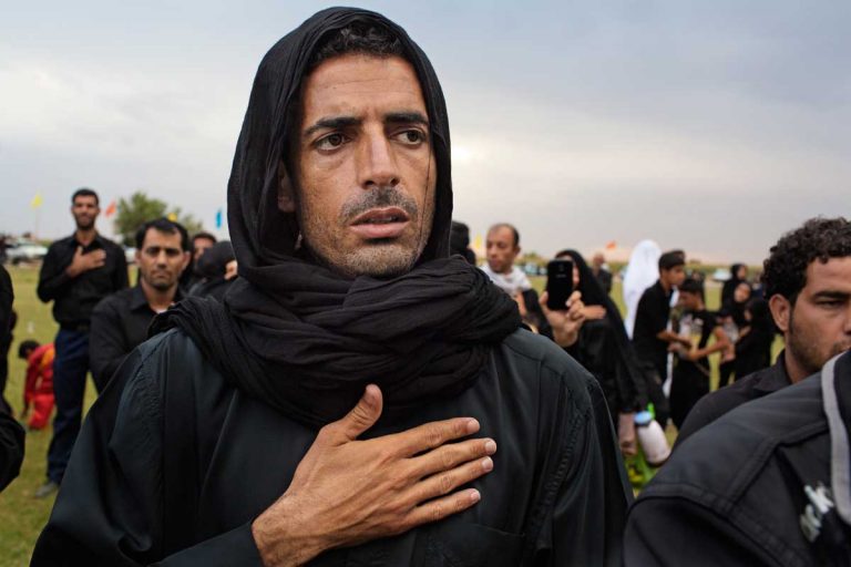 A man watching the play of the martyrdom of Hussein during the celebration of Ashura. Iran, Shush, November 2014.