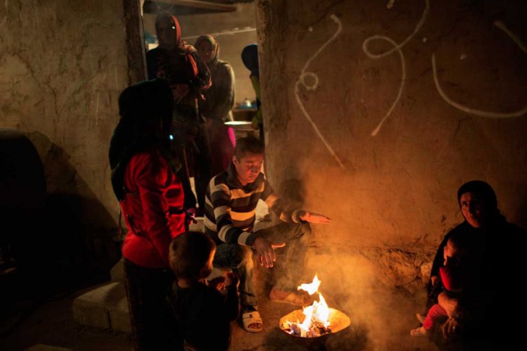 Ghaffar and his family around the fireplace a few days before the transplant. Ghaffarâ??s family had to sell all their lands to buy the kidney. Iran, November 2014.