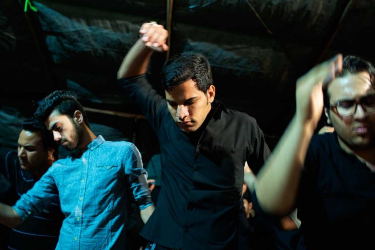 The celebration of the Ashura lasts till late night. During this dance people beat their chest with strength and anger. Iran, Ahvaz, November 2014.