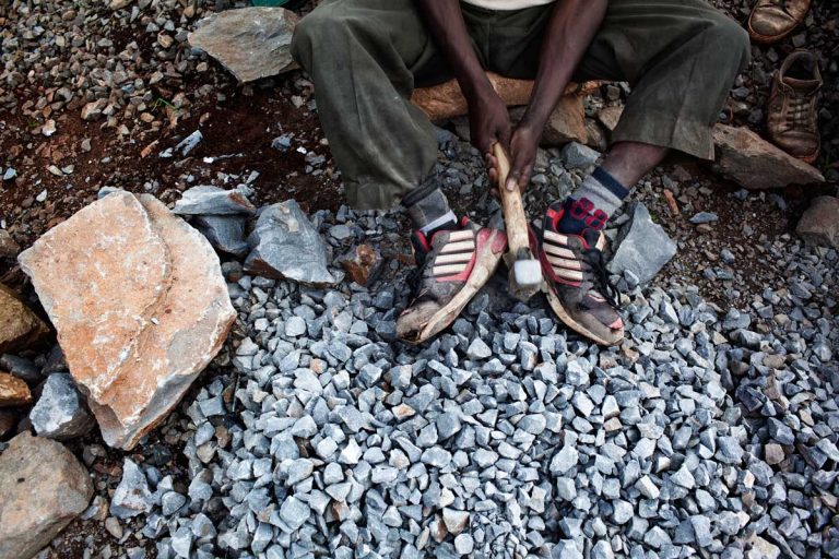 Bekoji, Ethiopia. August 2013. After runners finish training in the forest they keep wearing the shoes while working. Running shoes are the most popular in Bekoji. Almost everybody wears them, not just the runners.